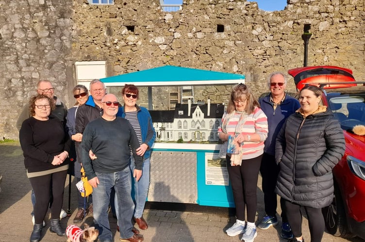 Group pictured by the restored Charity Dolls House in Tenby