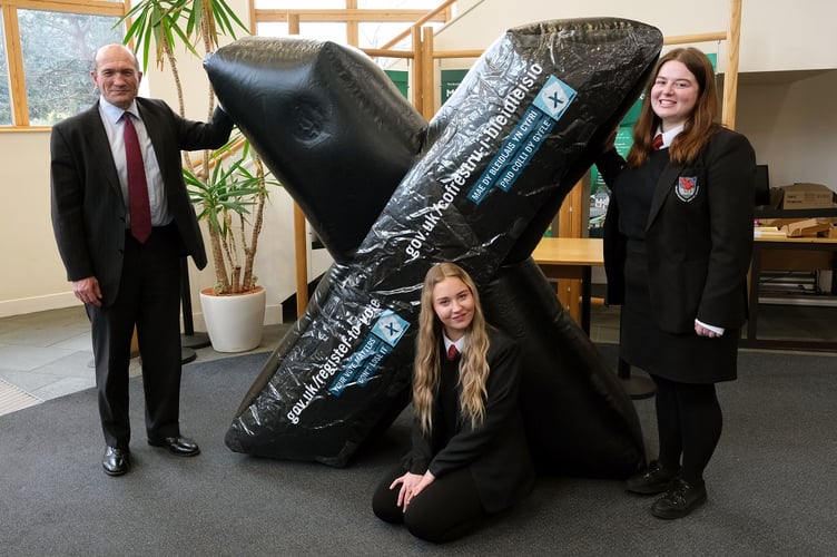 Returning Officer Will Bramble and Haverfordwest High students Lucy Ashton and Anna Ford.