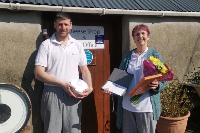Rosebush Postmistress Cynthia Jennings with son Jason holding dairy farm cheese