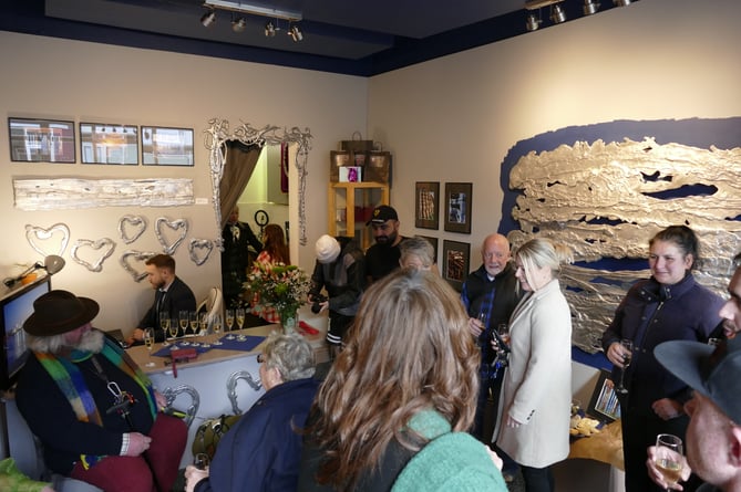 A crowded Dockside Art Gallery on opening day