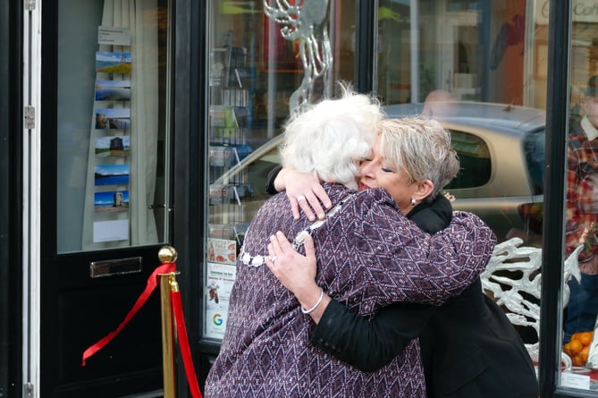 Cllr Pamela George and gallery owner Dawny Tootes hug after the opening of the shop in Dimond Street, Pembroke Dock