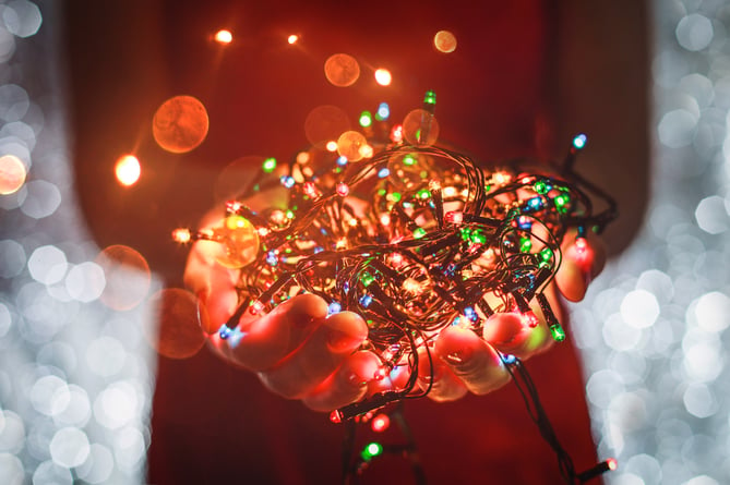 Hands holding bundle of New Year's Eve or Christmas lights