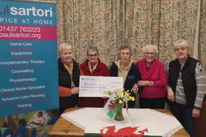 Eglwyswrw Village Association Committee hands over the funds raised at the coffee morning to the Paul Sartori charity