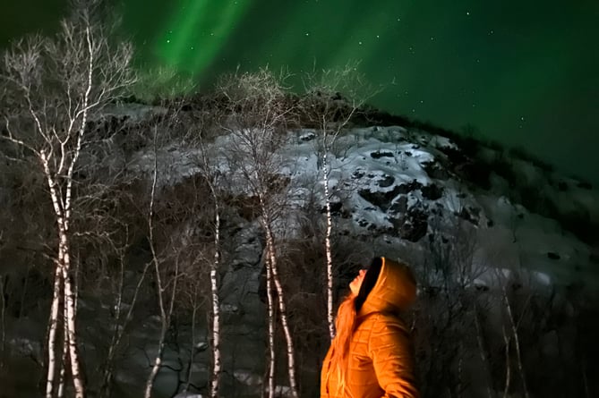 Jodie Marie looking up at the Northern Lights