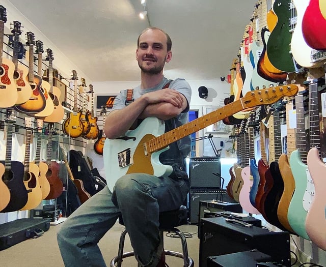 TV crew visiting Pembroke check out guitar George