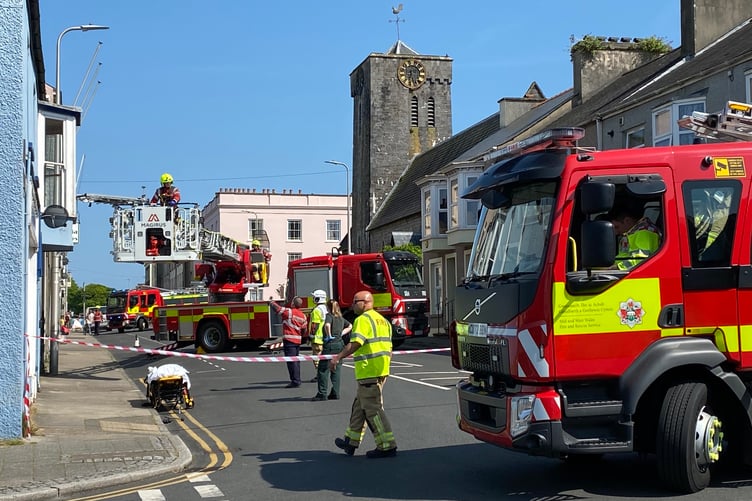 Pembroke Dock and Haverfordwest crews assisting the removal of a casualty through an upstairs window in Bush Street, Pembroke Dock