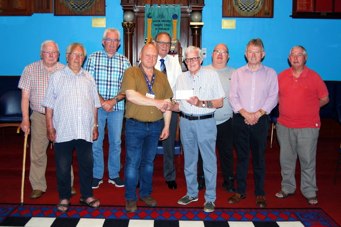 Worshipful Master W.Bro Steven Evans presenting a cheque for £200 to Mr Mel Jenkins who received the cheque on behalf of the Urdd National Eisteddfod. The donation was matched by the Masonic Province of West Wales making the total £400. On this occasion the Worshipful Master was accompanied by members of the Narberth Lodge.