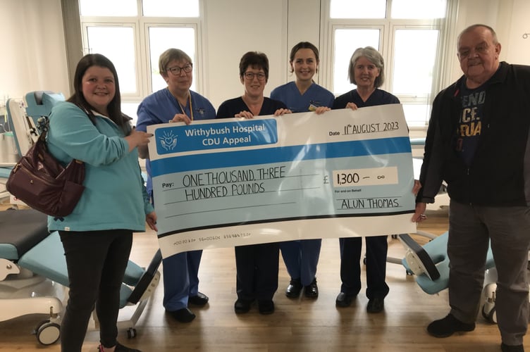 Enfys and Alun presenting their donation to the nursing team at the Unit.