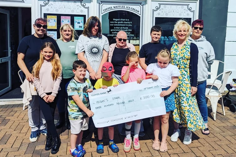 Limelight School students handing over the cheque for £300 to the Megans Starr Foundation