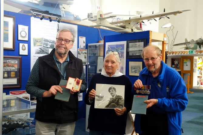 Mrs Patzi Harradine with members of the Heritage Centre team, Trevor Clark (left) and John Evans, display the George Medal and other donated items.