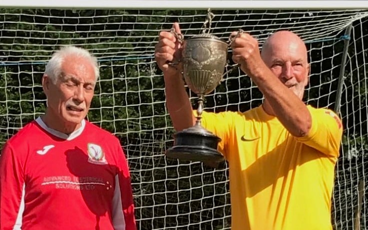 Mark Brindley, the captain of NHSU being presented with the cup from the Welsh captain.