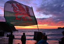 Competitors take in the Welsh national anthem at Ironman Wales 2022