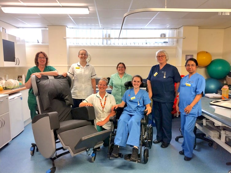Staff from Gwenllian Ward in Glangwili Hospital with one of the specialist chairs.