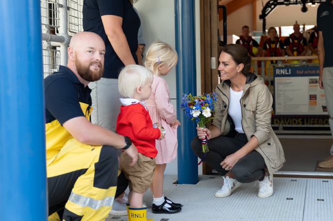 Isla and Arthur Kohler presenting the Princess of Wales with a posy at St Davids RNLI