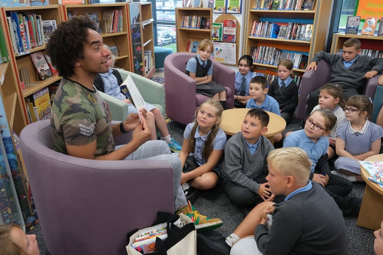 Waterstones Children’s Laureate Joseph Coelho at Milford haven Library with children from St Francis School.