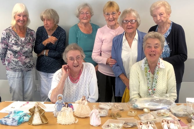 Saundersfoot WI members with some of the intricate dolls displayed by Secretary Sue.