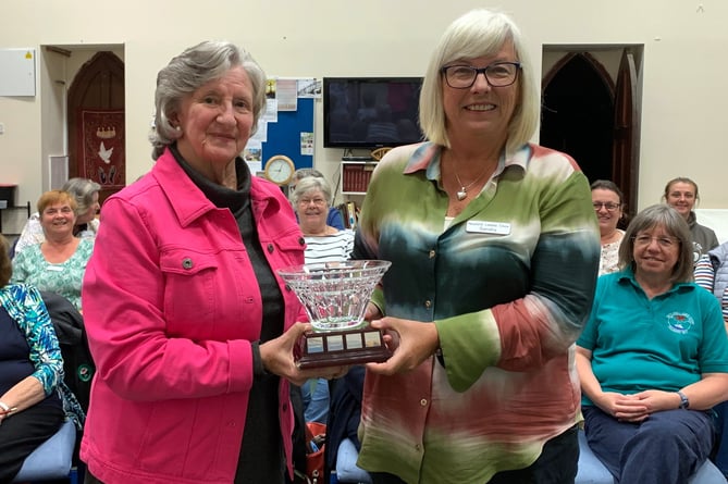 Chair Sandra Western receiving the Waterford crystal rosebowl from outgoing Chair Trisha Campodonic. This unique rosebowl was presented to the choir at the Waterford Crystal factory in Ireland whilst on tour in Ireland to celebrate the choirÕs 20th Anniversary in 1997.