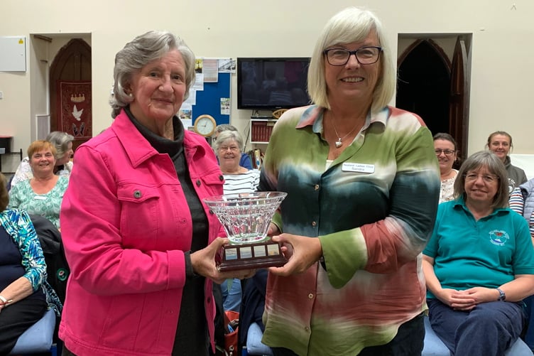 Chair Sandra Western receiving the Waterford crystal rosebowl from outgoing Chair Trisha Campodonic. This unique rosebowl was presented to the choir at the Waterford Crystal factory in Ireland whilst on tour in Ireland to celebrate the choirÕs 20th Anniversary in 1997.