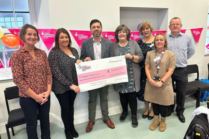 Stephen Crabb MP presenting the cheque at the Day service Launch on Wednesday, September 27. Pictured are Cllr Di Clements; trustee Jane Smith; Stephen Crabb MP; trustee Gill Leese; Laura Long Ð Share the Care; trustee Cherry Evans and David Howlett, representing Paul Davies AM.