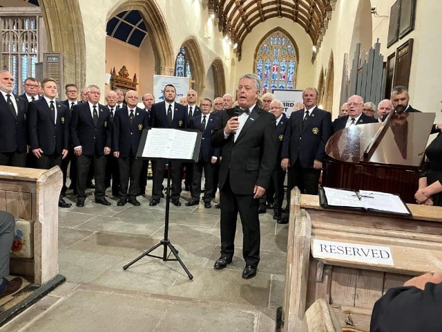 Compere for the evening and Chairman of Pembrokeshire Friends of Prostate Cymru Ð Brian Harries, surrounded by members of Haverfordwest Male Voice Choir.