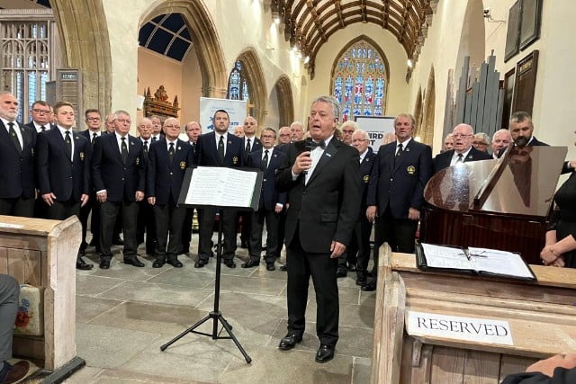 Compere for the evening and Chairman of Pembrokeshire Friends of Prostate Cymru Ð Brian Harries, surrounded by members of Haverfordwest Male Voice Choir.
