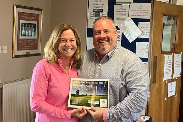 Joanne Owen presents Jon with his winner’s prize.