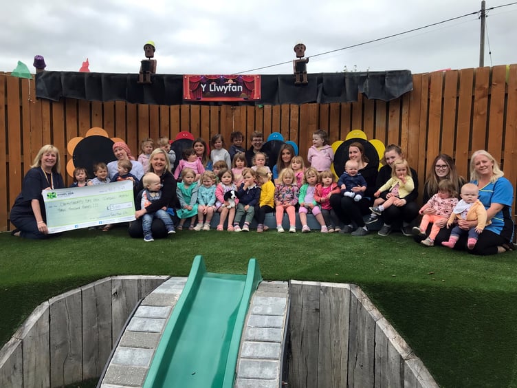 Claire Rumble, Fundraising Officer (left) with staff and children from Twts Tywi Nursery
