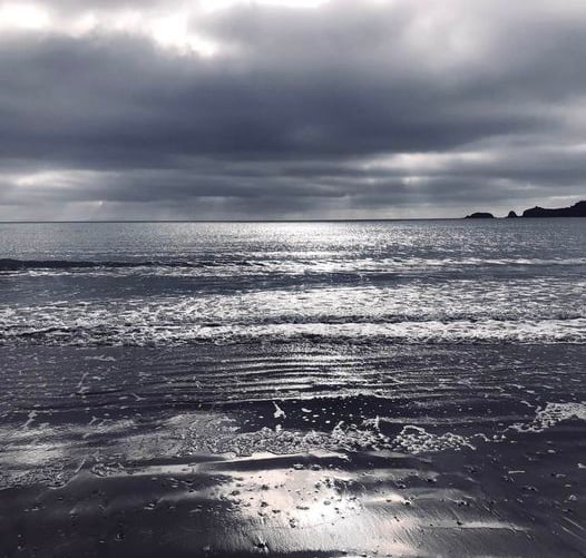 Early morning sun trying to break through the heavy cloud at Coppet Hall beach, Saundersfoot