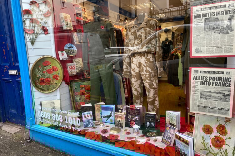A remembrance-themed charity shop window display in Pembroke