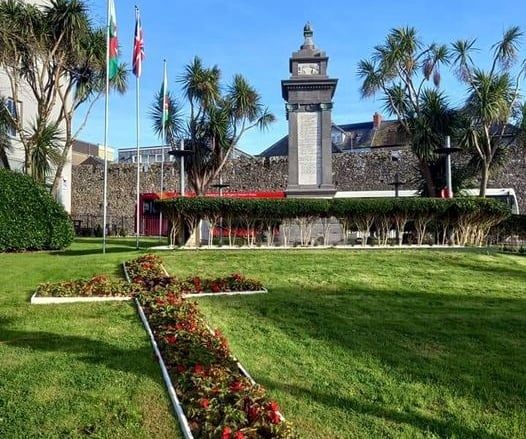 A cross of red geraniums at Tenby War Memorial Gardens