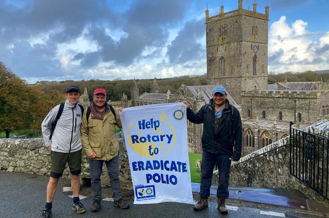 A wet, but smiling trio of Saundersfoot Rotarians helping to eradicate Polio with their walk around the St Davids peninsular coast path.