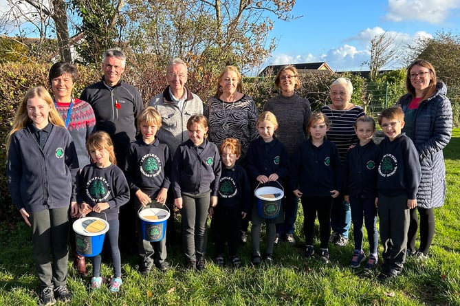With pupils of the school are Deputy Head Mrs Sarah Arthur, Headteacher Mr Phelps, Templeton Together Committee members Amanda Lee and Mark Norris, Templeton Community Council Members Cllr Kathrin Williams and Cllr Liz Burns and Friends of Templeton School Chair Ros Canney.