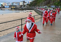 Soggy Santas take to seaside streets of Tenby for festive fundraiser