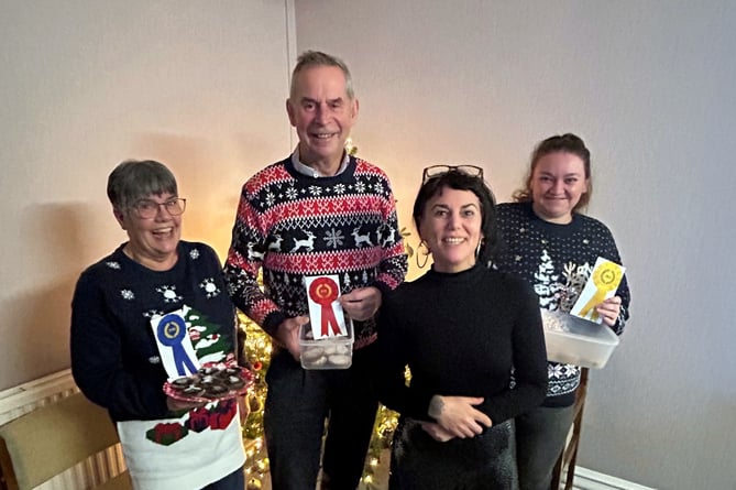 Pictured at the Hains & Lewis annual mince pie competition are: from left to right are: in second place, Carol Jones; in first place, Dan Lewis; judge Plum Vanilla and, lastly, in third place Alex Pieniak.