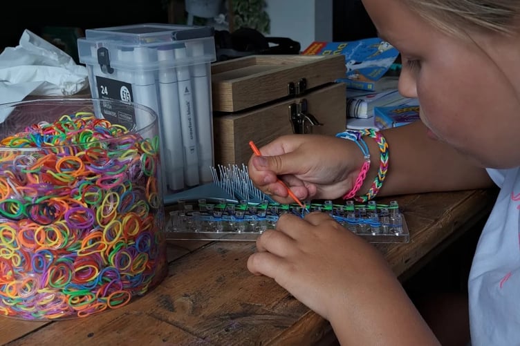 Grace making her bracelets