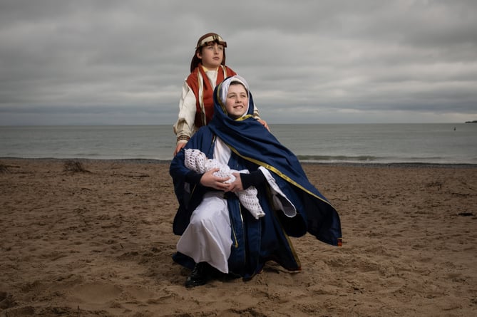 Pupils from St Teilo's Catholic Primary School, located in the popular seaside resort of Tenby, act out scenes from their nativity plays before they break for Christmas on Friday. All schools will have finally broken up for the Christmas holidays by either today or tomorrow. In the image Isabella Fairile plays Mary holding baby Jesus (bottom) and Euan Monan as Joseph (top) from Class 4,  on Tenbyâs South Beach, located just a stones throw from the school.