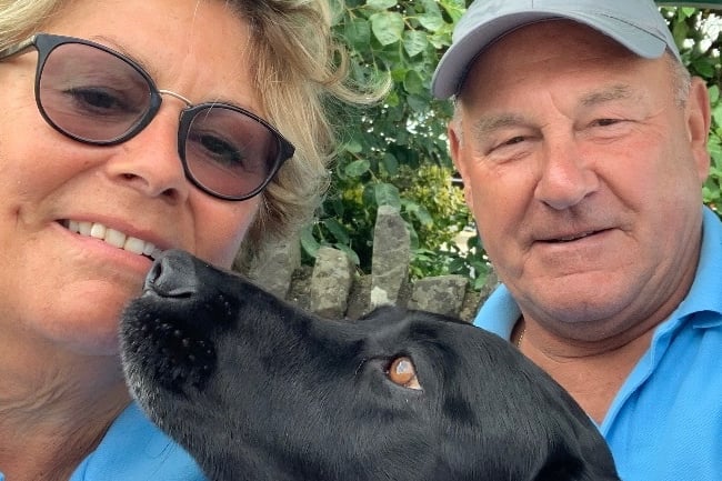 Helen and Tony Hedley with Blue, their black Labrador