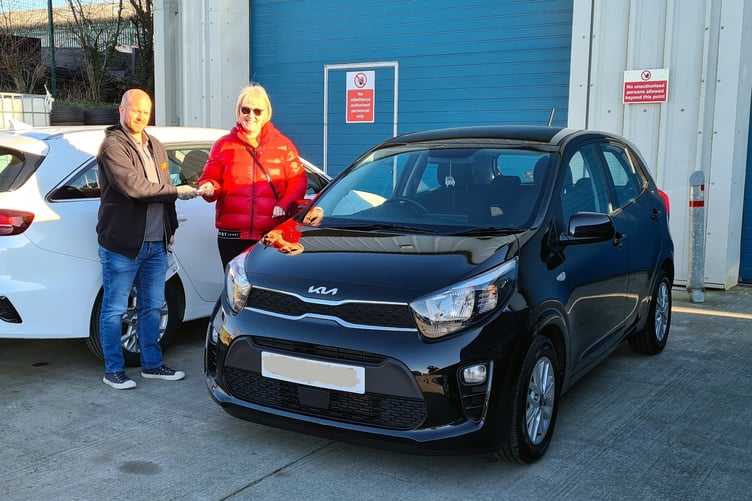 Homeless Pembrokeshire CEO Amanda Evans accepting the generous gift of a black Kia Picanto from Steve at GRS Motor Group, Milford Haven.