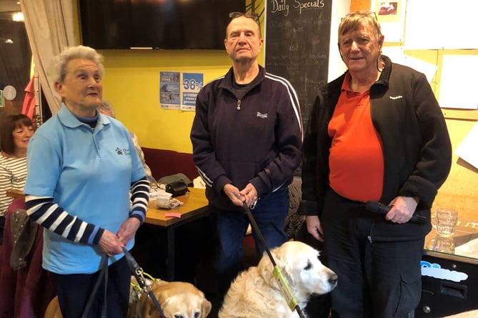 Pictured at a Guide Dogs Cymru Quiz Night at the Templebar Inn, Amroth, are Eva Rich with Nancy, John Woolsgrove with Eddie and Ian from the Templebar Inn with his dog Max.