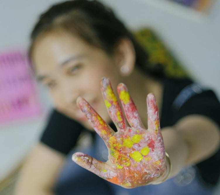 Happy girl with painted hand