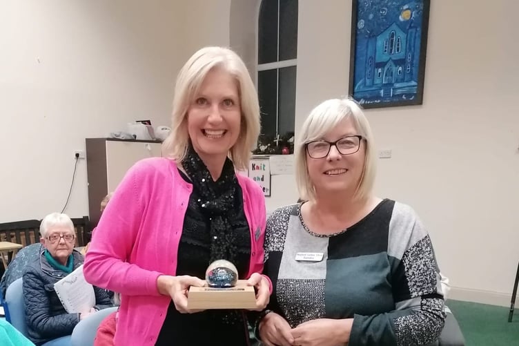 Chairlady Sandra Western presents the paperweight in memory of Grace Lewis to choir secretary Alison Davies.