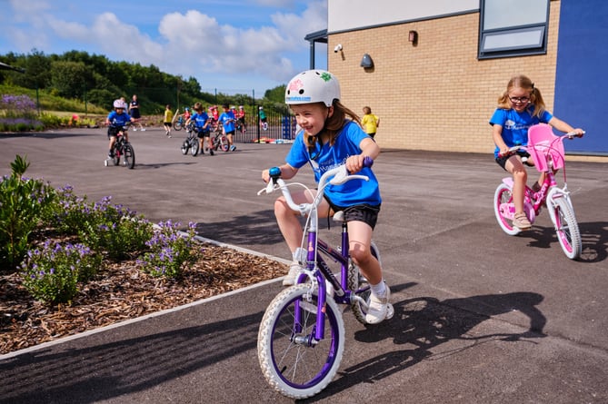 Children cycling into school