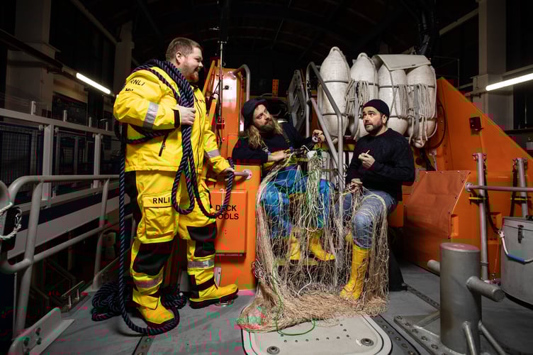 [In the image, left to right: Chris Thomas (Deputy Mechanic), Josh Hunt (ALB Crew), Phil John (Station Coxswain).] In a juxtaposition of old and new to celebrate 200 years of the RNLI, crew members from the iconic Tenby RNLI station, Pembrokeshire, pose on the back of their Tamar class all-weather lifeboat