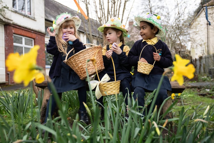 Pupils from St Teilo’s Catholic Primary School, Tenby, get in the Easter spirit with a colourful Easter bonnet parade and Easter egg hunt before they break up for the Easter holidays on Friday, March 22nd. Schools around the UK begin to break up for their holidays between this Friday, 22nd, and Good Friday, 29th. In the image (left to right): Isabella Brooks, Rhiannon Clewer and Daya Joby (all from Reception)