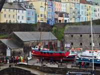WATCH: Tenby's boats get a helping hand back into the harbour waters
