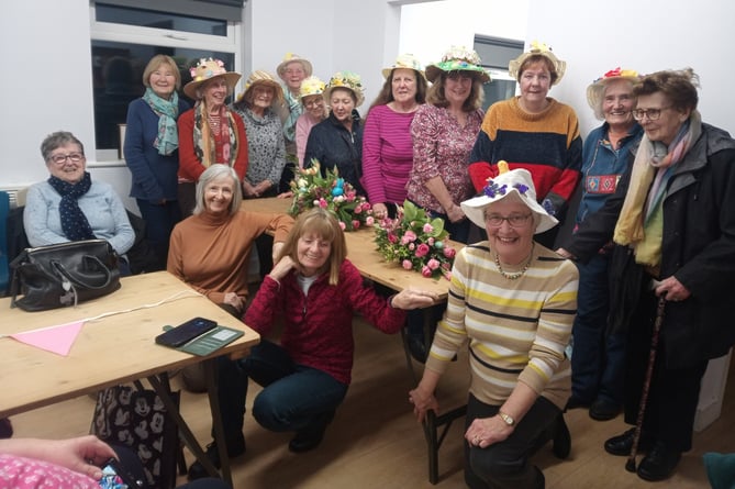 Hundleton WI members - wearing their Easter Bonnets - with guests for the evening.