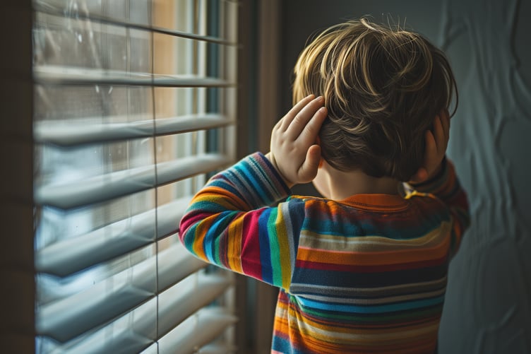 ai-generated image of boy with hands on ears