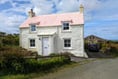 Look inside this pastel cottage for sale with "superb" coastal views 