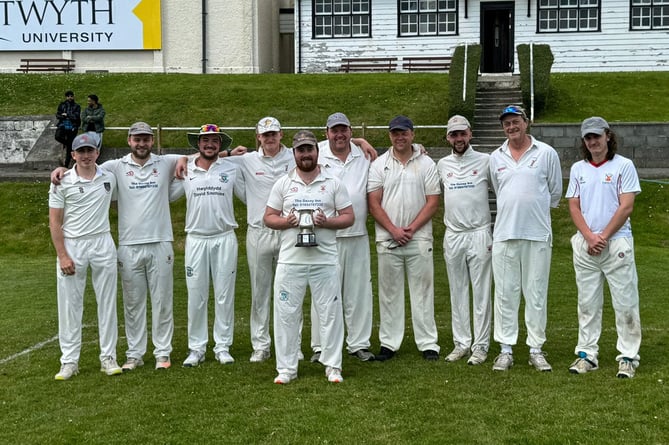 Tywyn Cricket Club celebrate receiving the 2023 WWCCC trophy prior to their first match of the season