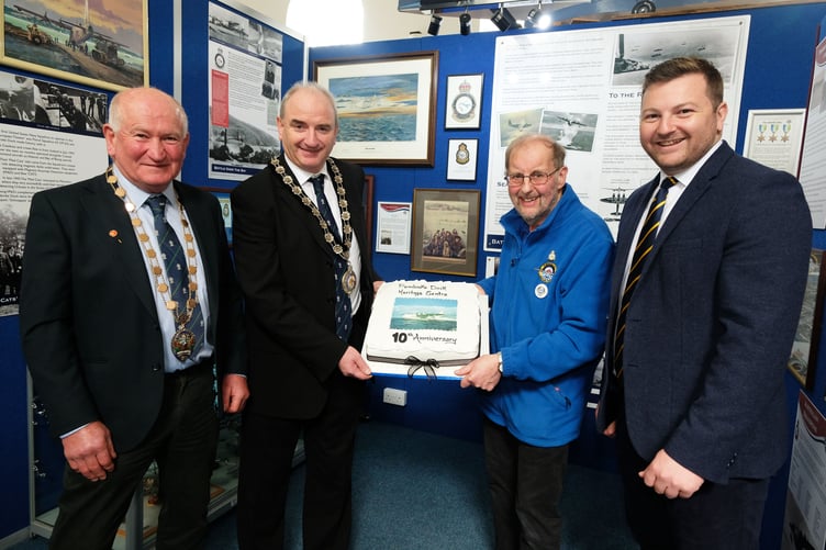 The Sunderland cake is shown by John Evans, Patron of the Pembroke Dock Heritage Trust, to (left to right) Councillors Steve Alderman and Tom Tudor and Sam Kurtz, MS.
